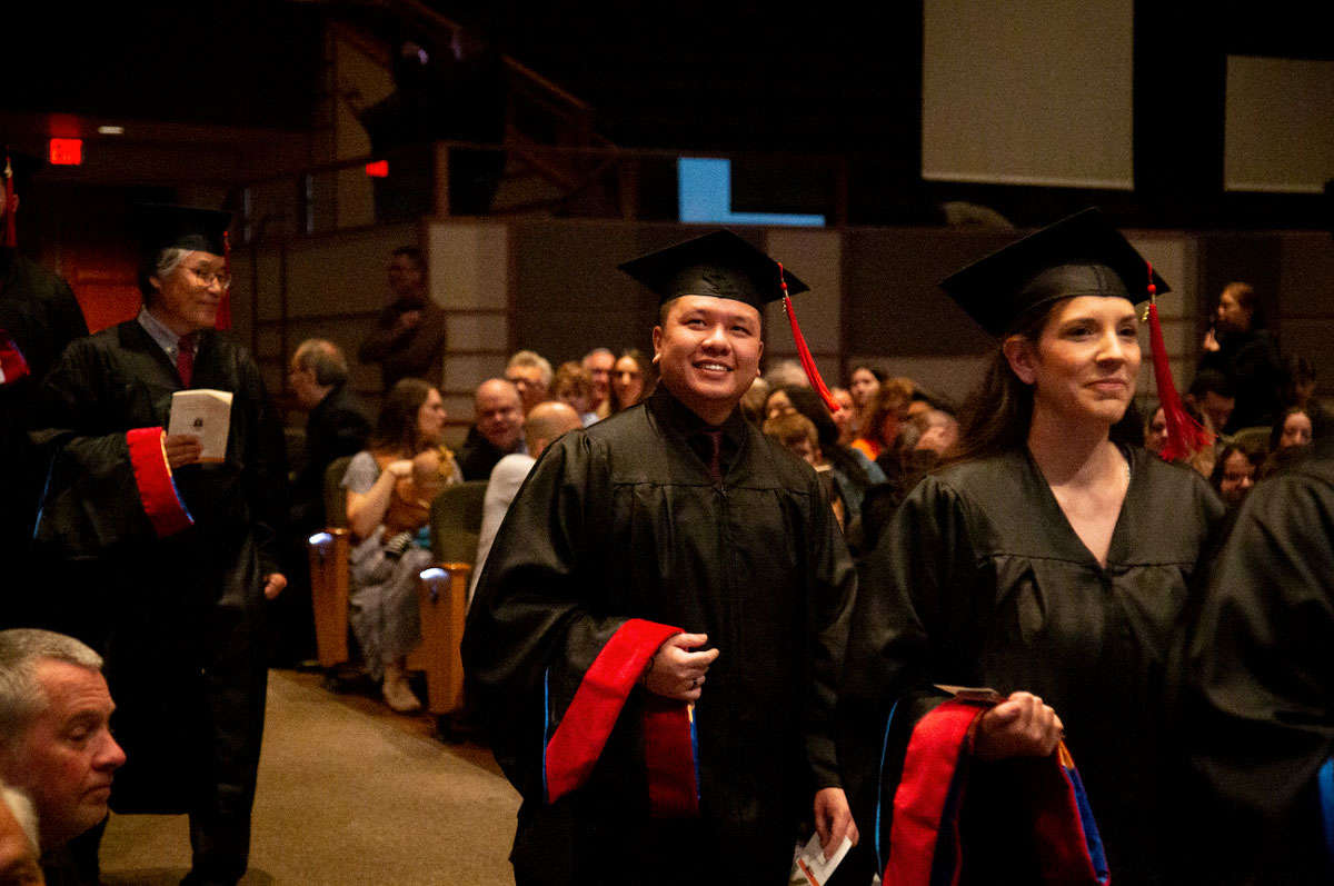graduates walk down aisle