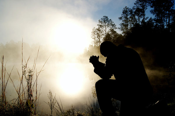 Man on his knees praying