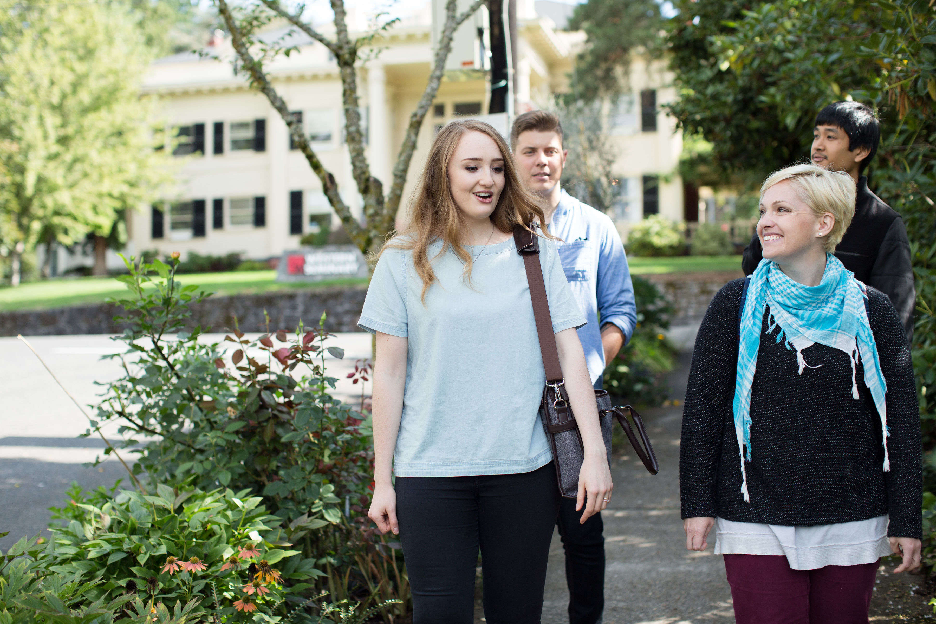 Photograph of staff and students walking and talking