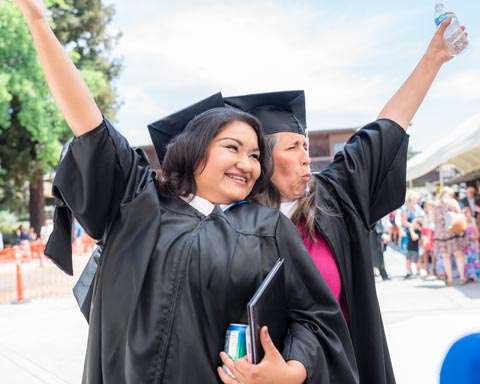 Graduates cheering.